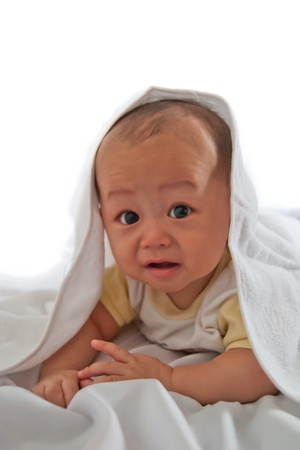 baby in white towel start to cryの写真素材