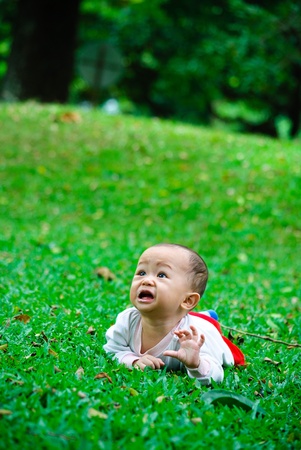 crying in a green field の写真素材