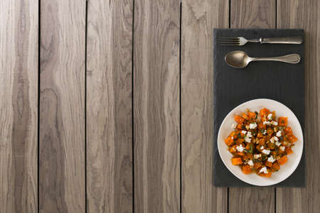 Roasted pumpkin with maple and feta cheese. top view. copy space.