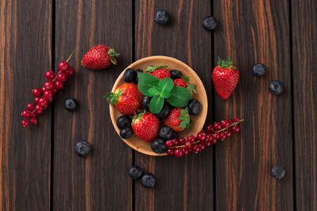 Plate with fresh strawberry blueberry and red currant.の写真素材