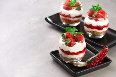 strawberrie dessert, cheesecake, trifle, parfaits on gray stone. copy space background.の写真素材