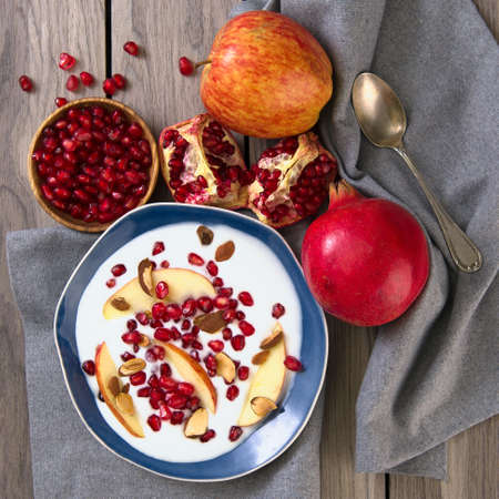 Pomegranate-Apple Salad with Greek Yogurt and almonds. top viewの写真素材
