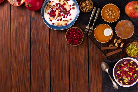 assorted of fall foods and desserts on wooden background. healthy eating. vegan. top view. copy space.の写真素材