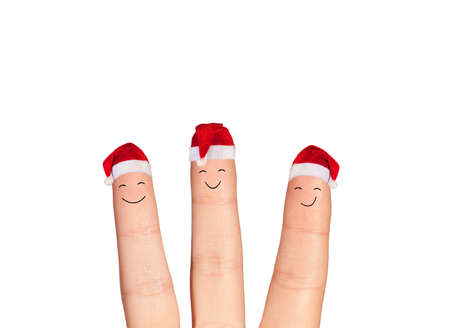 Fingers faces in Santa hats isolated on white background. Happy family celebrating concept for Christmas day.の写真素材