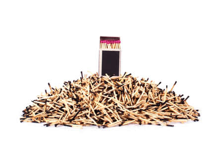 Matchbox with matches on a background of burnt matchesの写真素材