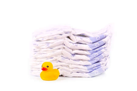Disposable diapers and the rubber duckling, isolated on whiteの写真素材