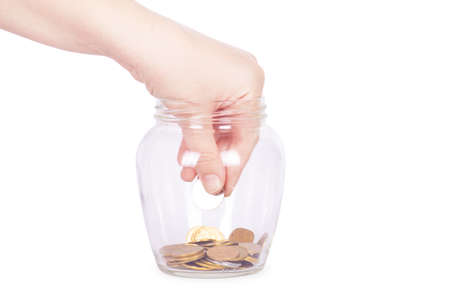 image of female hand putting a coin into glass bottle, saving concept