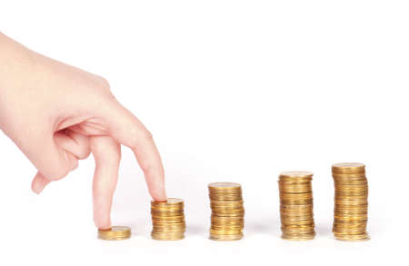 Coins column and fingers isolatedの写真素材