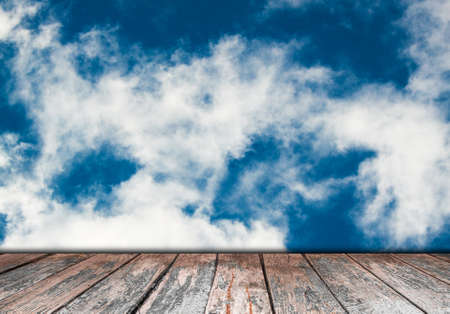 Abstract blue sky and clouds with wooden paving.の写真素材
