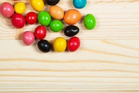 different colorful sweets on the wooden tableの写真素材