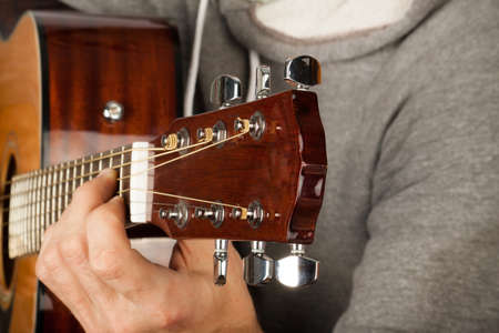 young man playing guitarの写真素材