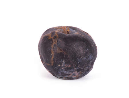 Wrinkled rotten apple on a white background.の写真素材
