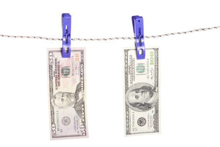Dollar bills hanging on rope attached with clothes pins. Money-laundering concept.の写真素材