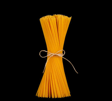 Uncooked spaghetti isolated on black backgroundの写真素材