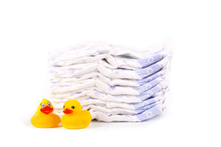 Disposable diapers and the rubber duckling, isolated on whiteの写真素材