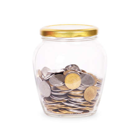 Coins in glass money jar, on white backgroundの写真素材