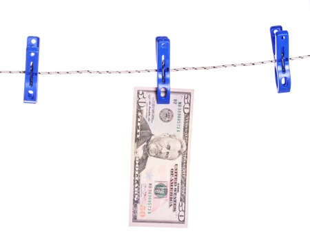 Dollar bills hanging on rope attached with clothes pins. Money-laundering concept.の写真素材