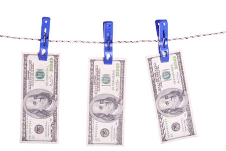 One hundred dollar bills hanging on a clothes pinsの写真素材