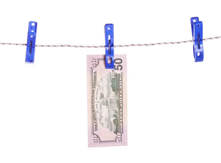 Dollar bills hanging on rope attached with clothes pins. Money-laundering concept.の写真素材