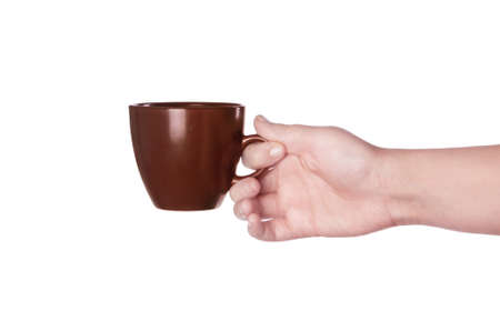 Brown cup of coffee in hand isolated on white backgroundの写真素材