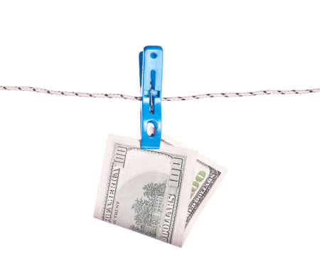 Dollar bills hanging on rope attached with clothes pins.の写真素材
