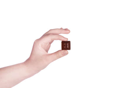 Hand hold pieces of chocolate. Isolated on a white background.の写真素材