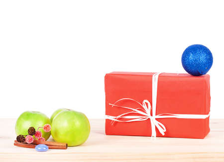 Present wrapped in red paper on a wooden backgroundの写真素材