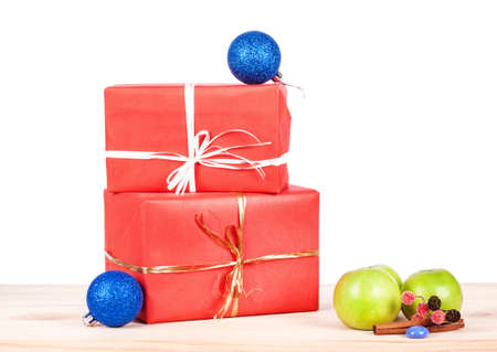 Present wrapped in red paper on a wooden backgroundの写真素材