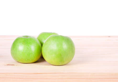 Green apples on the wooden backgroundの写真素材