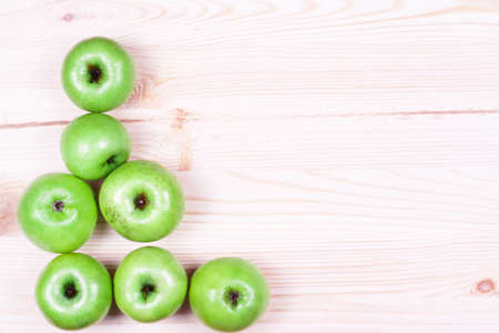 Green apples on the wooden backgroundの写真素材
