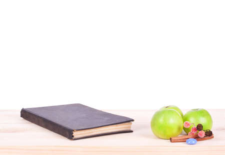 Book and apples on desk, isolated on whiteの写真素材
