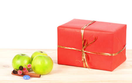 Present wrapped in red paper on a wooden backgroundの写真素材