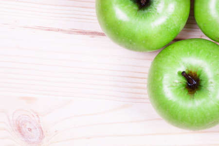 Green apples on the wooden backgroundの写真素材