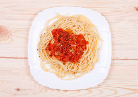 spaghetti and tomato sauce on wooden tableの写真素材