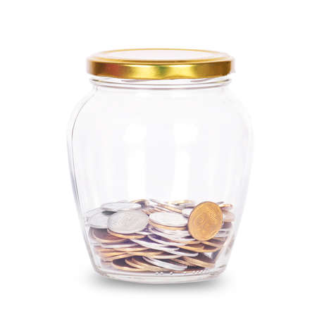 Coins in glass money jar, on white backgroundの写真素材