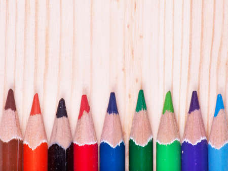 Colored pencils on wood background with space for your textの写真素材
