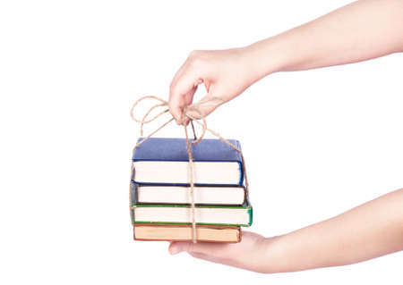 hand giving pile of book as a gift of knowledgeの写真素材