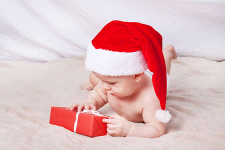Beautiful little baby celebrates Christmas. New Year's holidays. Baby in Santa hatの写真素材