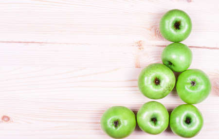 Green apples on the wooden backgroundの写真素材