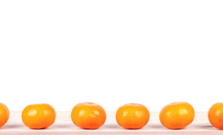 A mandarine on wooden table. Empty copy space for editor's text.の写真素材