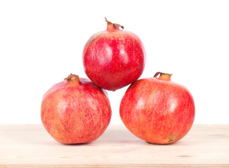 Ripe pomegranate fruit with half isolated on white backgroundの写真素材