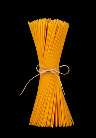 Uncooked spaghetti isolated on black backgroundの写真素材