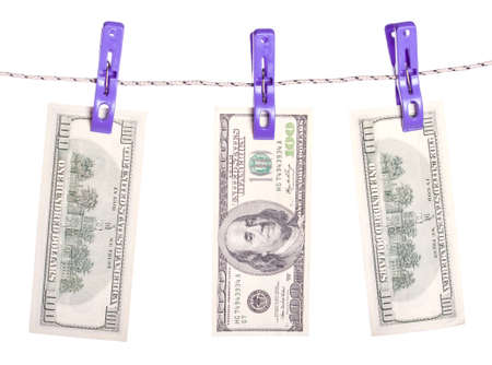 Dollar bills hanging on rope attached with clothes pins. Money-laundering concept.の写真素材