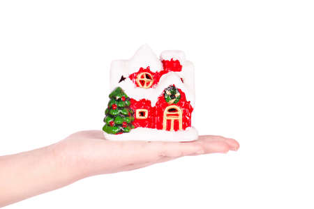 Hand holding a christmas house on white backgroundの写真素材