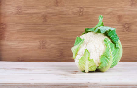 Ripe cauliflower on wood shelfの写真素材