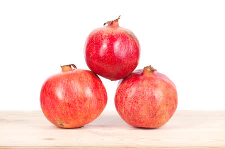 Ripe pomegranate fruit with half isolated on white backgroundの写真素材