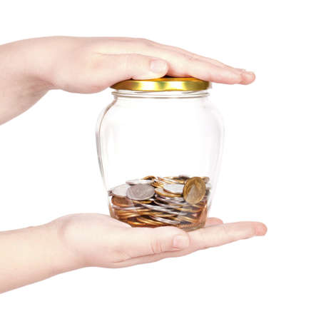 image of female hand putting a coin into glass bottle, saving conceptの写真素材