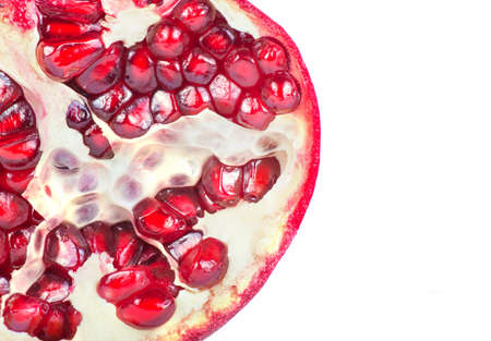 Ripe pomegranate fruit with half isolated on white backgroundの写真素材