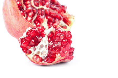 Ripe pomegranate fruit with half isolated on white backgroundの写真素材