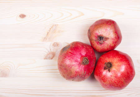 Ripe pomegranate fruit with half isolated on white backgroundの写真素材